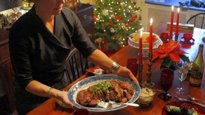 Post-Gazette food writer Gretchen McKay places a tray of roast tenderloin with creamy mustard sauce onto her dinner table at her home in Ben Avon.
