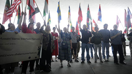 Demonstrators hold flags of many nations during the G 6 Billion march through Downtown yesterday.