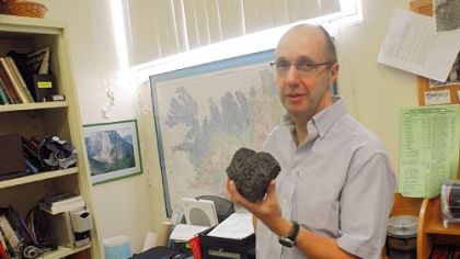 Dr. Ian Skilling, volcanology professor at the University of Pittsburgh, shows a rock from an Icelanic volcano.