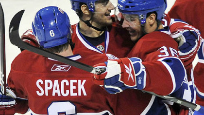 Canadiens forward Matt D''Agostini, right, is congratulated by teammates Max Pacioretty, center, and Jaroslav Spacek after scoring during the second period.