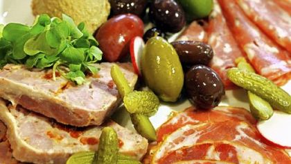 Le Pommier serves house-made country pate and chicken liver mousse with cured meats and assorted olives.