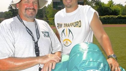 First-year head coach T.J. Wiley (right) and his father, John, the offensive coordinator, on the first day of football practice at Penn-Trafford High School in August.