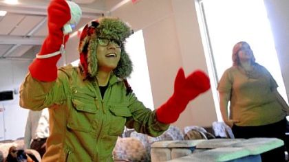 Cooper Yoo, 27, a first-year graduate student at the Entertainment Technology Center, throws a virtual snowball using a Nintendo Wii controller while playing Snowball Mania, a game he developed with four other Carnegie Mellon University students. The snow hat on his head contains a sensor that allows him to duck out of the way of incoming snowballs.