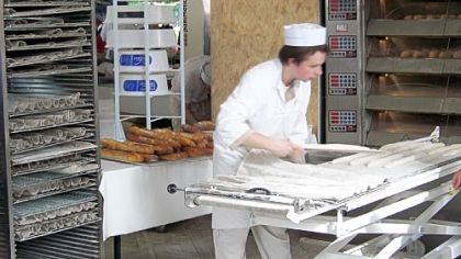 A baker makes baguettes at la Fete du Pain, the annual Festival of Bread in Paris.