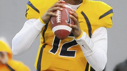Geno Smith came on for the injured quarterback Jarrett Brown and helped lead the Mountaineers to a 24-7 victory against in-state rival Marshall.