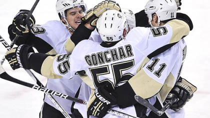 Penguins defensemen Kris Letang, left, Sergei Gonchar and forward Jordan Staal celebrate a goal by teammate Matt Cooke, not shown,  during the second period.