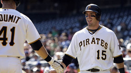 Pirates third baseman Andy LaRoche is greeted by teammate Ryan Doumit after scoring on a single by Pirates first baseman/outfielder Garrett Jones in the second inning.