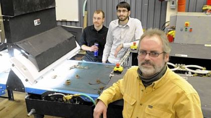 Chris Fromme, front, the principal investigator of the strawberry plant sorting project of Carnegie Mellon University's National Robotics Engineering Center, Ben Koopman, left, software engineer and Rich Pantaleo, mechanical engineer, are developing this robot to evaluate the growth of strawberry plants.