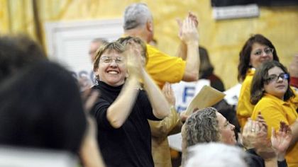 Helen Gerhardt, an organizer with the Pittsburgh Interfaith Impact Network cheers during the group's meeting last night at Epiphany Catholic Church in Uptown.