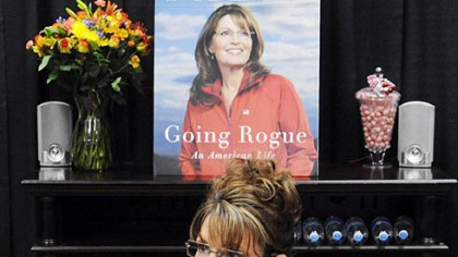 Former Vice Presidential nominee Sarah Palin signs copies of her book yesterday at Sam's Club in South Strabane.