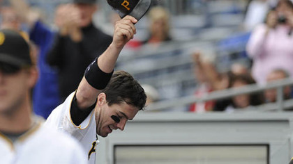 Pirates third baseman Andy LaRoche raises his helmet after a two-run home run in the bottom of the eighth inning.