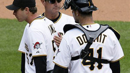 Pitcher Zach Duke, left, is pulled from the game in the ninth inning with two outs and with a 10-run lead by manager John Russell, center, as catcher Ryan Doumit stands by.