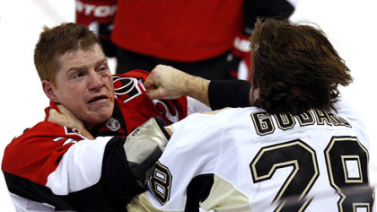 Senators forward Chris Neil fights with Penguins forward Eric Goddard during the third period.