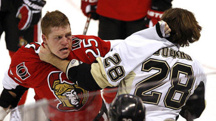 Eric Godard, right, battles with Ottawa's Chris Neil in the Penguins' 6-2 blowout loss to the Senators Thursday.
