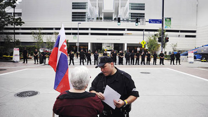An interfaith march organizer speaks with police, who blocked marchers from taking the road underneath the David Lawrence Convention Center yesterday