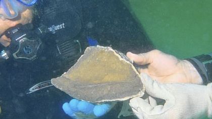 From the summer Mercyhurst trip to the Gulf of Mexico off Florida with James Adovasio and C. Andrew Hemmings, searching for signs of early human activity: Mr. Hemmings holds sample of chert, the hard stone from which prehistoric people made tools and weapons.