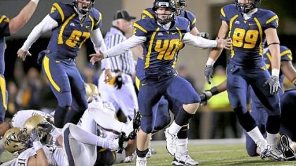 West Virginia's Tyler Bitancurt celebrates after kicking the winning field goal against Pitt as time expired last night at Mountaineer Field in Morgantown, W.Va.