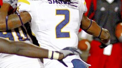 In one of the most talked-about plays of Friday's game, Cincinnati's Isaiah Pead, top, goes over West Virginia defensive back Robert Sands for what ultimately was ruled a touchdown for the No. 5 Bearcats. Pead lost the ball on the play, but officials ruled he scored before losing the ball.