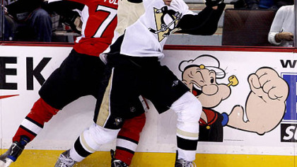 Senators forward Nick Foligno is checked by Penguins forward Michael Rupp during the second period.