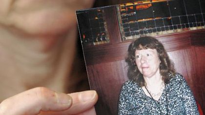 Carol Kolb of Ross holds a photo of what she looked like before she went on Sanford Siegal's cookie diet.