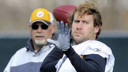 Steelers quarterback Ben Roethlisberger throws the ball as offensive coordinator Bruce Arians watches at practice at the team's facility on the South Side yesterday.