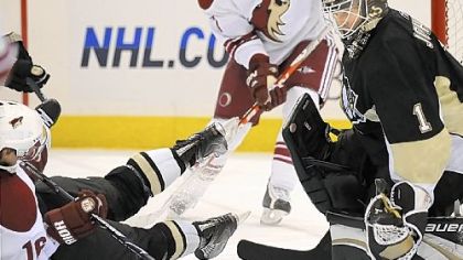 Penguins goalie Brent Johnson makes save on Phoenix's Petr Prucha in a game earlier this month.