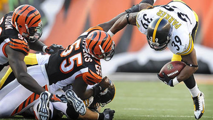 The Steelers' Willie Parker is upended by the Bengals' Keith Rivers yesterday. Parker carried the ball 25 times for 93 yards and caught a touchdown pass.