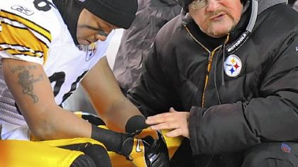 Steelers wide receiver Hines Ward is consoled by wide receivers coach Randy Fichtner in the final seconds of the Steelers' loss at Cleveland Browns Stadium last night.