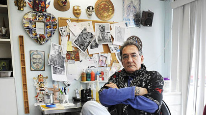 Nick Bubash, owner of Route 60 Tattoo, poses for a portrait inside his shop off of the Steubenville Pike.