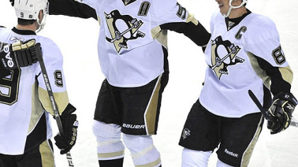 Penguins defenseman Sergei Gonchar, center, celebrates after scoring in the first period with teammates Sidney Crosby, right, and Pascal Dupuis.