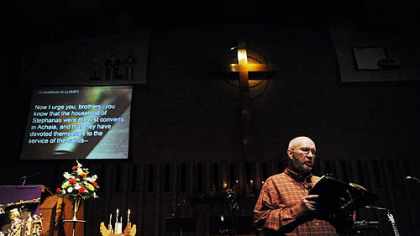 The Rev. Bob Titus reads scripture as it is projected onto a screen for all the church to see during a "contemporary" service held at the Lebanon Presbyterian Church on Dec. 6.