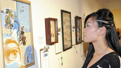 Yuko Asano looks at the art.