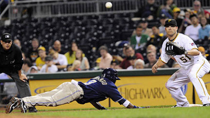 Padres outfielder Luis Durango gets back to first base safely as Pittsburgh Pirates first baseman  Steve Pearce awaits the throw in the eighth inning.