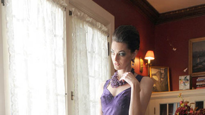 Purple corset dress by Taryn Rose, $478; necklace by Amp, $278; earrings by Nina, $158.  All available at Victoria, Fox Chapel.