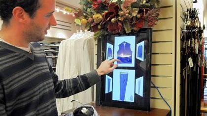 Carnegie Mellon student Philip Croul demonstrates how to use a Smart.Mirror to help coordinate clothing in the Charles Spiegel for Men store in Squirrel Hill.