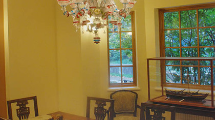 A Murano glass chandelier hangs over the dining room table. Dr. Anti built the whaling boat in the glass case.