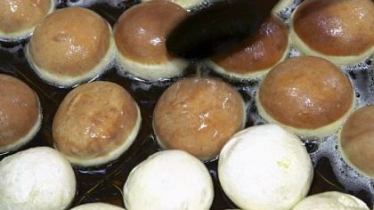 Sufganiyot (doughnuts) being fried for Hanukkah.