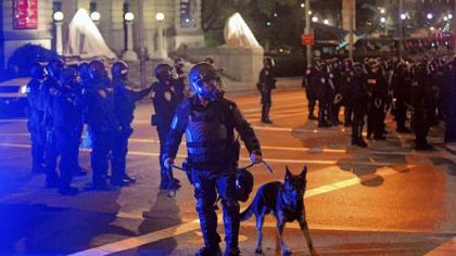 Riot police respond to the crowd gathered in Schenley Plaza.