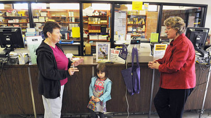 Shirley Gasper, of Beechview, with her granddaughter, Diamond Marie Petrocelli, 6,  talks with Audrey Iacone, right, the manager of the Beechview Carnegie Library branch. Ms. Gasper said she has been coming to the library for 43 years and brings her granddaughter, but the tradition will end when the city library system closes the branch in February.