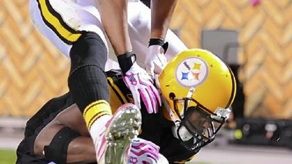 Hines Ward hurdles over Mewelde Moore, who scores in the first half against the Chargers last night at Heinz Field.