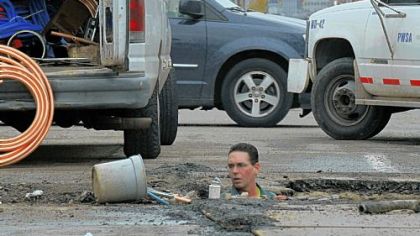 Tony Mazzocco, a plumber with the Pittsburgh Water and Sewer Authority, works on replacing an aging water line with a copper one along Penn Avenue near 29th Street in the Strip District last month.
