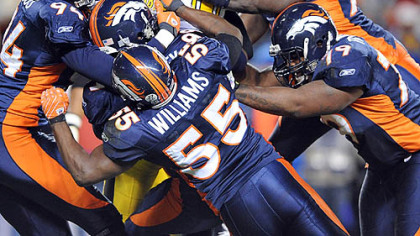 Steelers quarterback Ben Roethlisberger is gang tackled by the Broncos during Denver's 31-28 home win in the 2007 season.