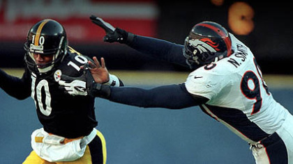 Steelers quarterback Kordell Stewart tries to elude Broncos defensive end Neil Smith during the 1997 AFC Championship Game at Three Rivers Stadium.