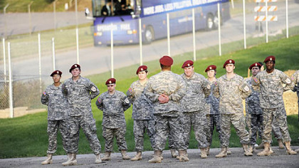 Members of the Pittsburgh Job Corps Center Leadership Academy stand as the bus carrying veterans with Operation Free arrives at the center in East Liberty yesterday.
