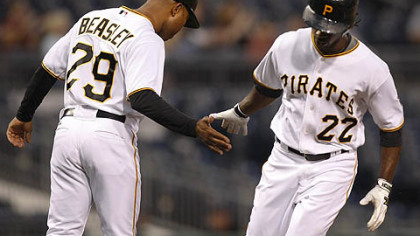 Pirates outfielder Andrew McCutchen is greeted by third base coach Tony Beasley after hitting a home run last night.