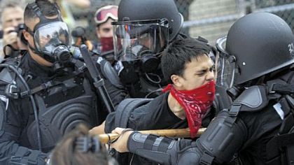 Police arrest a man that approached them during an unlawful protest march that began at Arsenal Park in Lawrenceville and tried unsuccessfully to make its way to the David L. Lawrence Convention Center Downtown yesterday.