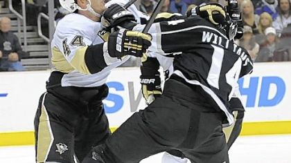 Pittsburgh Penguins defenseman Brooks Orpik (44) and Los Angeles Kings right wing Justin Williams (14) fight over the puck during the second period of a NHL hockey game, Thursday, Nov. 5, 2009, in Los Angeles. (AP Photo/Gus Ruelas)