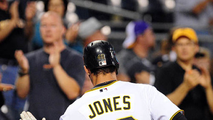 Pirates outfielder Garret Jones is congratulated after hitting a solo home run off Padres starting pitcher Wade LeBlanc in the first inning.