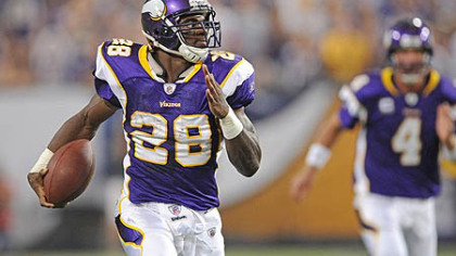 Vikings running back Adrian Peterson, right, and quarterback Brett Favre.