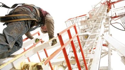 Joseph Bolin on Wednesday climbs down from a natural gas drilling rig derrick contracted by Range Resources in Washington County.